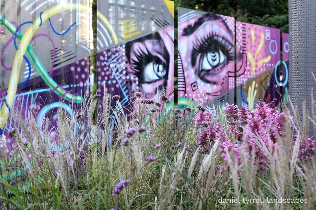 Laneway garden with graffiti artwork and bluestone pavers